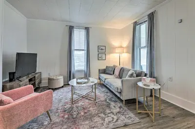 a living room with a couch and a tv at Pet-Friendly Greenville Home with Private Yard in Greenville