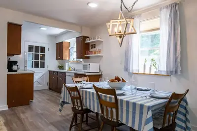 a kitchen and dining room with a table and chairs at Lakefront for 8, Near KY Speedway, Belterra Casino in Sparta