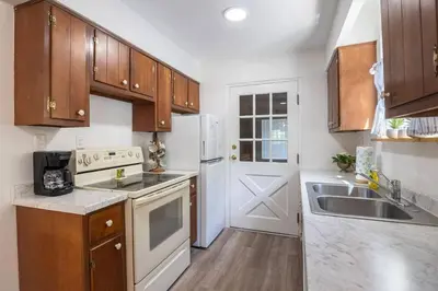 a kitchen with white appliances and wooden cabinets at Lakefront for 8, Near KY Speedway, Belterra Casino in Sparta