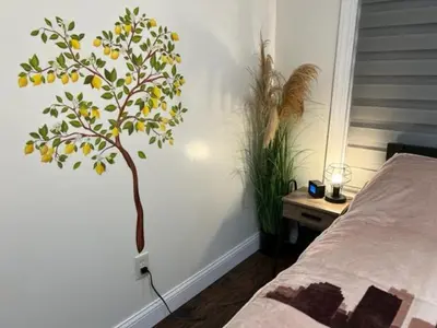 a bedroom with a tree painted on the wall at Uber Close to Ohio City, Cleveland (Lower) in Cleveland
