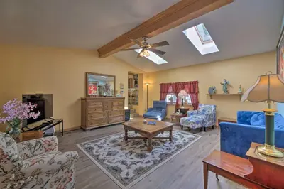 a living room with blue furniture and a ceiling fan at Charming Hanoverton Cottage on Guilford Lake! in Lisbon