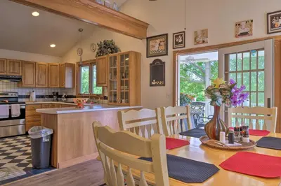 a kitchen and dining room with a table and chairs at Charming Hanoverton Cottage on Guilford Lake! in Lisbon