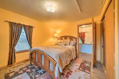 a bedroom with a bed and a large window at Charming Hanoverton Cottage on Guilford Lake! in Lisbon