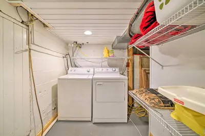 a kitchen with a washer and dryer in a room at Charming Hanoverton Cottage on Guilford Lake! in Lisbon