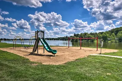 a playground with a slide in a park next to a lake at Charming Hanoverton Cottage on Guilford Lake! in Lisbon