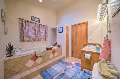 a bathroom with a tub and a sink and a shower at Charming Hanoverton Cottage on Guilford Lake! in Lisbon