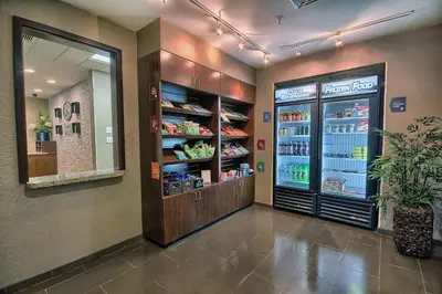 a grocery store aisle with a refrigerator with drinks at Comfort Suites Marietta-Parkersburg in Marietta