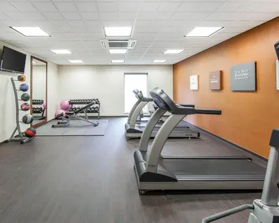 a gym with treadmills and elliptical machines at Comfort Suites Marietta-Parkersburg in Marietta
