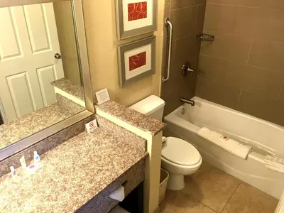 a bathroom with a toilet and a tub and a sink at Comfort Suites Marietta-Parkersburg in Marietta