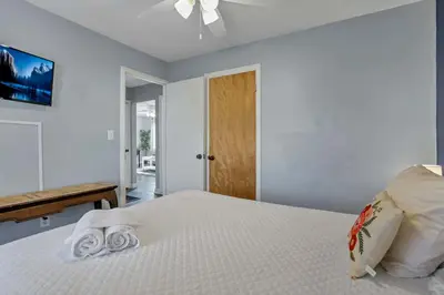 a bedroom with a bed with towels on it at Housepitality - The Sunset House in Columbus