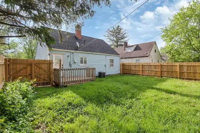 a backyard with a wooden fence and a house at Housepitality - The Sunset House in Columbus