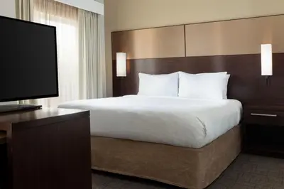a bedroom with a large bed and a flat screen tv at Residence Inn by Marriott Columbus Polaris in Columbus