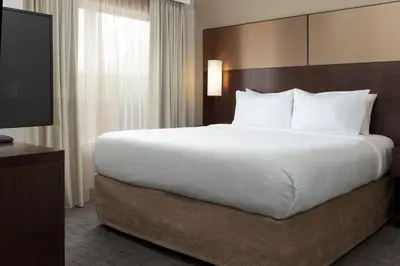 a large bed in a hotel room with a television at Residence Inn by Marriott Columbus Polaris in Columbus