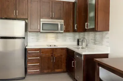 a kitchen with wooden cabinets and a stainless steel refrigerator at Residence Inn by Marriott Columbus Polaris in Columbus