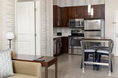 a kitchen with stainless steel appliances and a table at Residence Inn by Marriott Columbus Polaris in Columbus