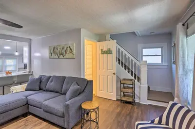 a living room with a couch and a staircase at Lorain Lake Cottage Less Than 1 Mi to Lake Erie Fun! in Lorain