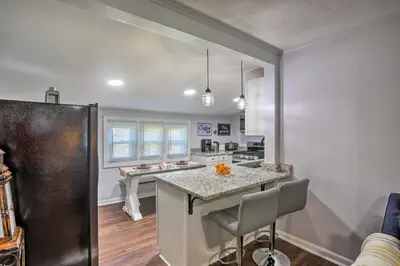 a kitchen with a large island in a room at Lorain Lake Cottage Less Than 1 Mi to Lake Erie Fun! in Lorain