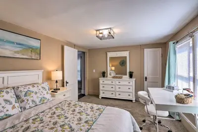 a bedroom with a bed and a desk and a sink at Lorain Lake Cottage Less Than 1 Mi to Lake Erie Fun! in Lorain