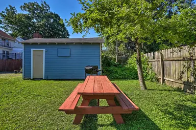 a picnic table in a yard with a blue shed at Lorain Lake Cottage Less Than 1 Mi to Lake Erie Fun! in Lorain