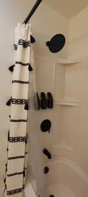 a bathroom with a shower curtain and a tub at Cozy Downtown Loft Apartment in Delaware