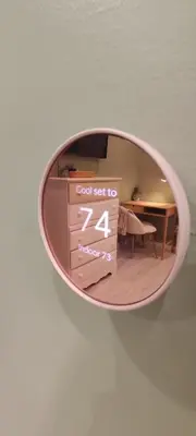 a round mirror hanging on a wall with a room at Cozy Downtown Loft Apartment in Delaware
