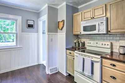 a kitchen with a stove and a microwave at Bright Parma Home with Outdoor Space Less Than 10 Mi to Dtwn in Parma