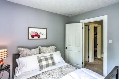 a bedroom with a bed and a wall with a mirror at Bright Parma Home with Outdoor Space Less Than 10 Mi to Dtwn in Parma