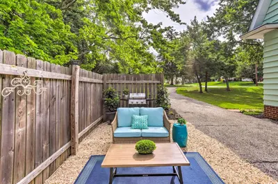 a patio with a blue couch and a wooden fence at Bright Parma Home with Outdoor Space Less Than 10 Mi to Dtwn in Parma