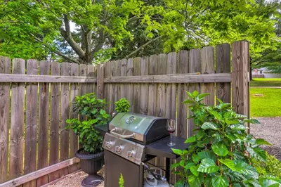a grill sitting on a table next to a fence at Bright Parma Home with Outdoor Space Less Than 10 Mi to Dtwn in Parma