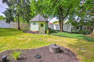 a small shed in a yard with a fire hydrant at Bright Parma Home with Outdoor Space Less Than 10 Mi to Dtwn in Parma