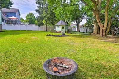 a backyard with a fire pit and a bird house at Bright Parma Home with Outdoor Space Less Than 10 Mi to Dtwn in Parma