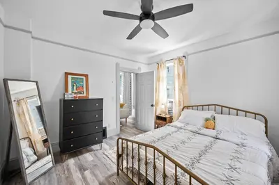 a bedroom with a bed and a ceiling fan at Center of Little Italy #2 in Cleveland