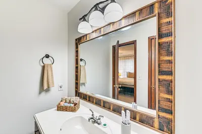 a bathroom with a sink and a large mirror at Williamstown Gem with Private Pool and Hot Tub! in Williamstown