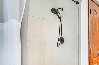 a shower head on a wall in a bathroom at Williamstown Gem with Private Pool and Hot Tub! in Williamstown