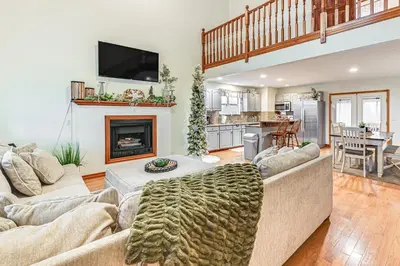 a living room with a couch and a fireplace at Williamstown Gem with Private Pool and Hot Tub! in Williamstown