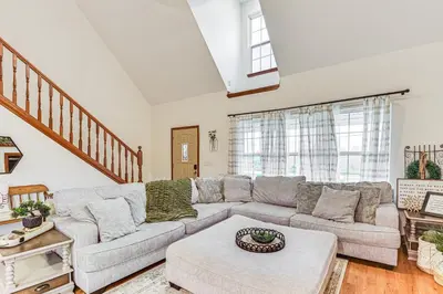 a living room with a couch and a table at Williamstown Gem with Private Pool and Hot Tub! in Williamstown