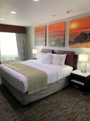 a large bed in a hotel room with two lamps at Days Inn by Wyndham Bellville Mansfield in Bellville