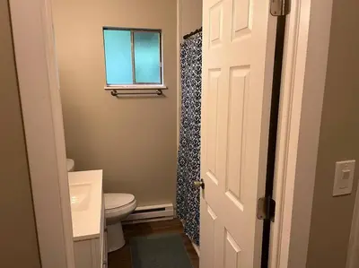 a bathroom with a toilet and a window at Carter #1 Two bedroom unit near Xavier Downtown in Cincinnati