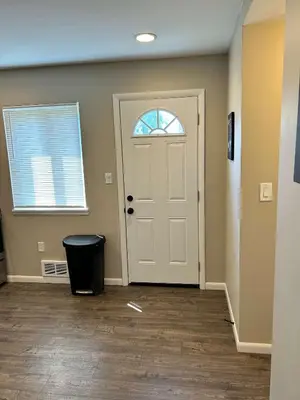 a room with a white door and a trash can at Carter #1 Two bedroom unit near Xavier Downtown in Cincinnati