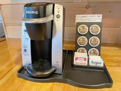 a coffee maker sitting next to a box at Cricket Hill Treehouse by Amish Country Lodging in Millersburg