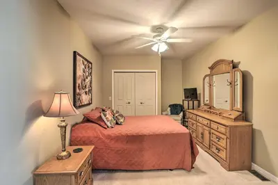 a bedroom with a bed and a dresser and a dresser at Cheerful Tiffin Digs in the Heart of Downtown in Tiffin