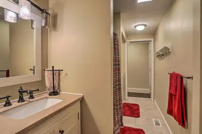 a bathroom with a sink and a walk in shower at Cheerful Tiffin Digs in the Heart of Downtown in Tiffin