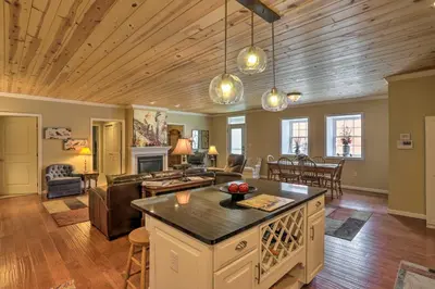 a kitchen and living room with a couch and a table at Cheerful Tiffin Digs in the Heart of Downtown in Tiffin