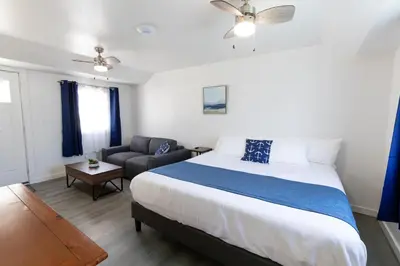 a bedroom with a large bed and a couch at Anchor Bay Inn and Suites in Sandusky