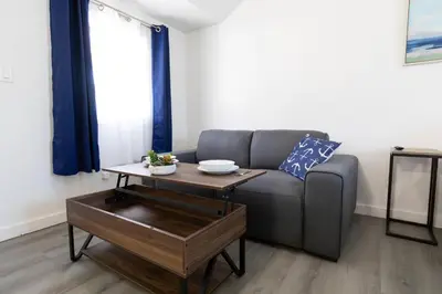 a living room with a couch and a coffee table at Anchor Bay Inn and Suites in Sandusky