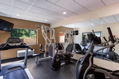 a gym with treadmills and elliptical machines at Best Western Logan Inn in Chapmanville