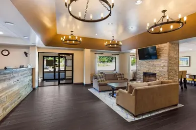 a living room with couches and a fireplace at Best Western Logan Inn in Chapmanville