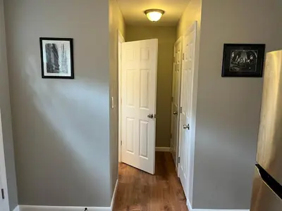 a hallway with a white door and a room with a floor at Carter #3 Two bedroom unit near Xavier Downtown in Cincinnati