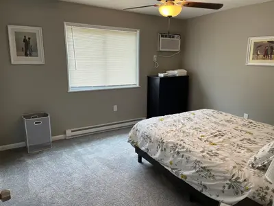 a bedroom with a bed and a window at Carter #3 Two bedroom unit near Xavier Downtown in Cincinnati
