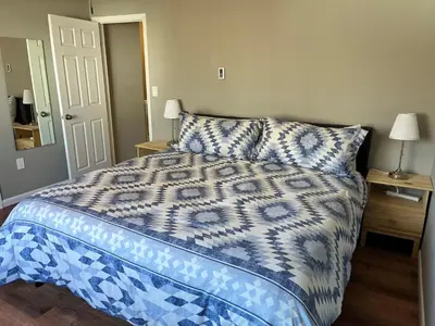 a bedroom with a bed with a blue and white comforter at Carter #4 Two bedroom unit near Xavier Downtown in Cincinnati